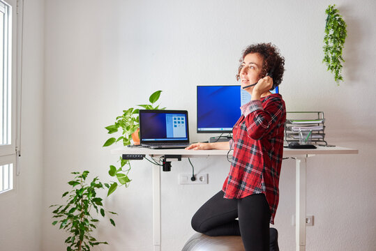 Woman telecommuting at an adjustable standing desk