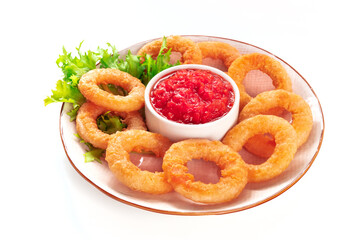 Calamari rings, isolated. Deep fried squid rings with green salad leaves and marinara sauce on a white background