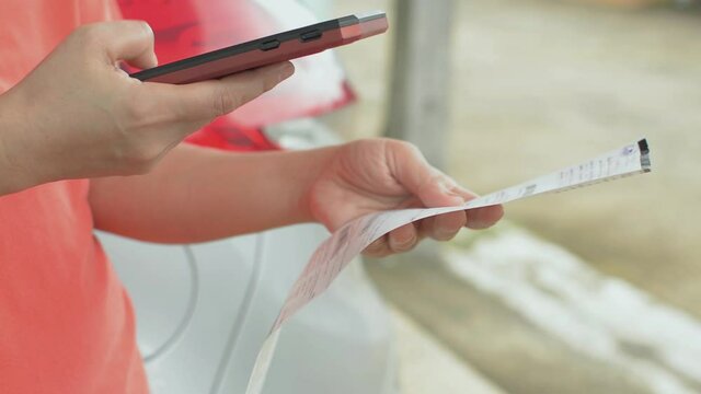 Receipt app for scanning. Tracking and managing bill. Woman scan QR code with mobile app. Payment of utility using Bar code with mobile device for electricity bill.