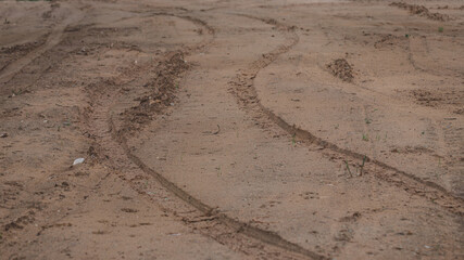 Fototapeta na wymiar car tire track prints on sand