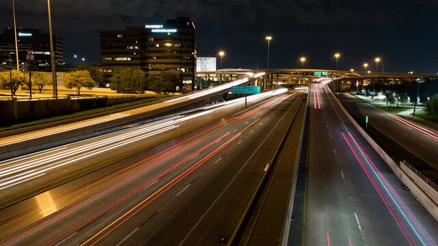 Streaks of car lights over highway interchange