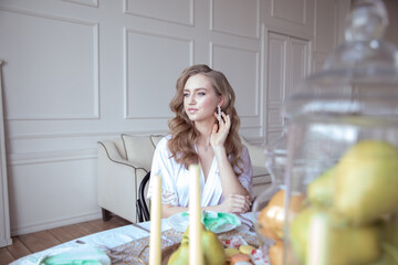 beautiful young girl in a white robe in a bright interior