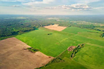 Aerial view of agricultural and green fields in countruside. Nature landscape in summer day