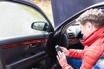 Man using the phone,smartphone in asking for help when his car is broken.Selective focus on phone.