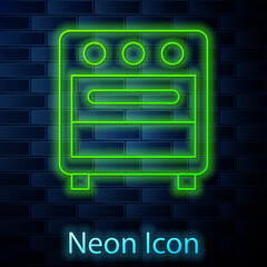 Glowing neon line Oven icon isolated on brick wall background. Stove gas oven sign. Vector