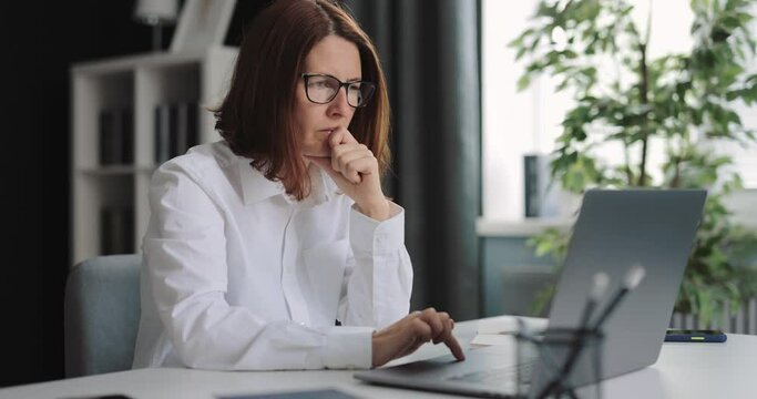 Thoughtful woman with laptop