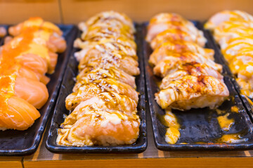 Various Japanese sushi is sold on a tray in a sushi shop.Thai market