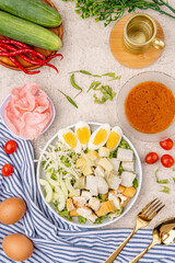 Fototapeta na wymiar Gado Gado is an Indonesian salad of slightly boiled, blanched or steamed vegetables and hard-boiled eggs, boiled potato, fried tofu and tempeh, and lontong, served with a peanut sauce dressing.
