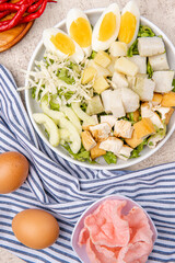 Gado Gado is an Indonesian salad of slightly boiled, blanched or steamed vegetables and hard-boiled eggs, boiled potato, fried tofu and tempeh, and lontong, served with a peanut sauce dressing.