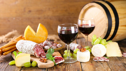 red wine glasses with cheese and salami