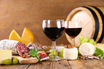 red wine glasses with cheese and salami