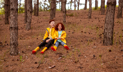 Happy ginger siblings in autumn forest