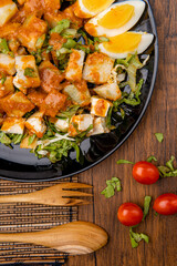 Gado Gado is an Indonesian salad of slightly boiled, blanched or steamed vegetables and hard-boiled eggs, boiled potato, fried tofu and tempeh, and lontong, served with a peanut sauce dressing.