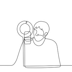 male blogger sitting in front of a ring lamp and a smartphone on a tripod - one line drawing. concept of live broadcast, stream. blogger or celebrity chatting with fans online, tutor leads the lesson