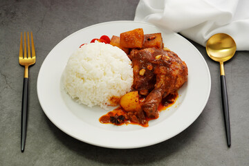Homemade Massaman Chicken with Chili Paste, Coconut Milk , Steamed Rice on a White Plate