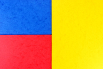 Blue, red and yellow color geometric paper composition background, top view