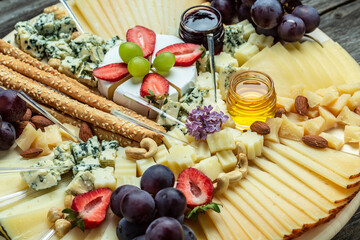 Antipasto Cheese board of various types of soft and hard cheese. spanish manchego cheese, aperitivo party concept. Food recipe background. Close up