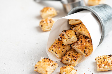 Homemade crackers close-up. Crackers with salt and spices on a gray background.