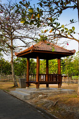 A wooden gazebo in the middle  of the park