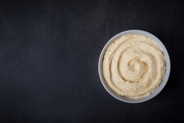 hummus from chickpeas on black background. Delicious homemade hummus