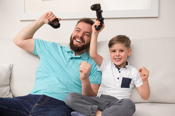 Father and son playing videogame together