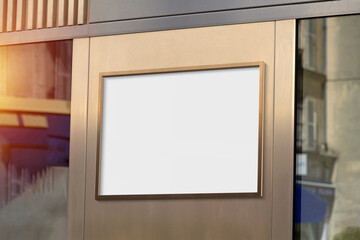 Metal frame hanging in street mockup. Template of a billboard on a wall bathed in sunlight 3D rendering