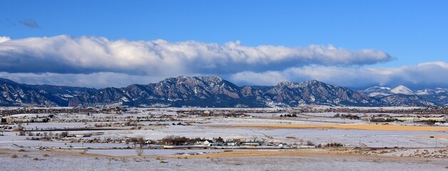 the  striking boulder flatirons and  snow -capped peaks of the front range of the colorado rocky...
