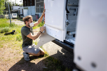 Man repairing the paint job on a van