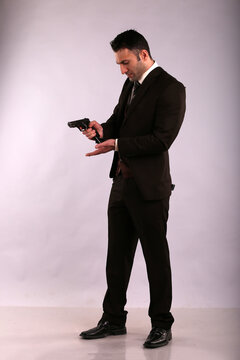 A man in jacket charging a gun