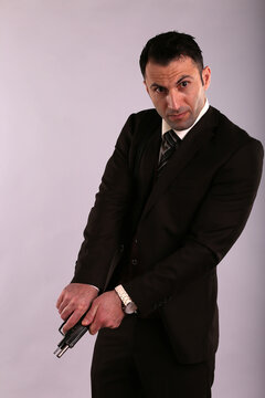 A man in jacket charging a gun