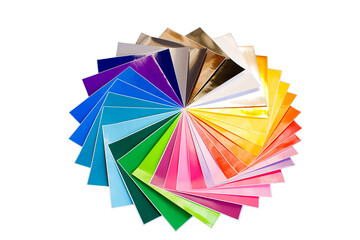 Twisted pile of colorful 12x12 sheets of adhesive paper isolated over the white background.