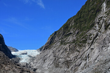 spectacular waterfalls and the terminus of the  franz joseph glacier as seen from the franz joseph glacier walk  overlook on the west coast of the south island of new zealand 