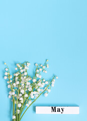 Blossoming lily of the valley on blue vertical background. copy space