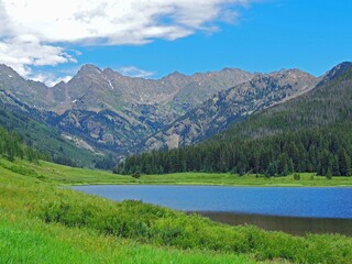   spectacular  piney lake and the gore range on a sunny summer day  near vail, colorado   