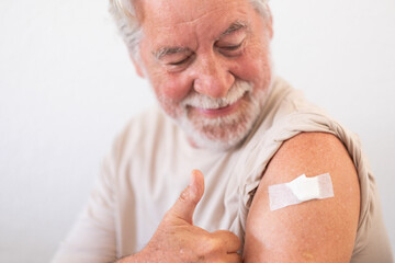 Smiling senior man 70s after receiving the coronavirus covid-19 vaccine.