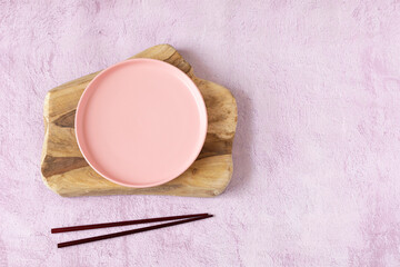 Pink table setting with chopsticks from above. copy space