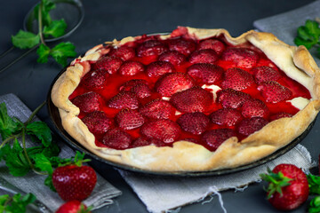 homemade puff pastry pie with fresh strawberries and mint 
