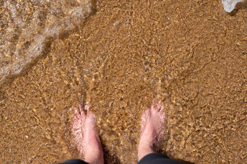 feet in the ocean after a hike