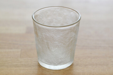 Empty glass on a wooden surface background
