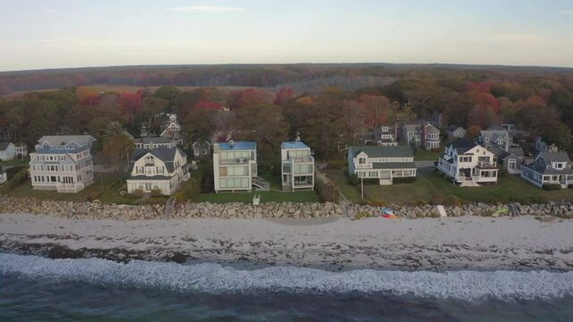 Aerial Moving Forward Over A Row Of Coastal New England Homes To Forest And Wetlands On The Horizon - Kennebunkport, Maine