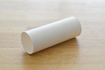 Toilet paper core on a rustic wooden table
