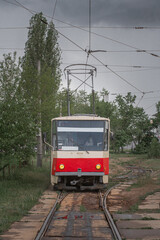 Fototapeta premium Old empty red Tatra T5 tram in cloudy day. View from the side.
