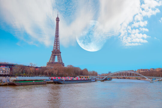 Paris Eiffel Tower and river Seine with full moon - Paris, France. Eiffel Tower is one of the most iconic landmarks of Paris "Elements of this image furnished by NASA "