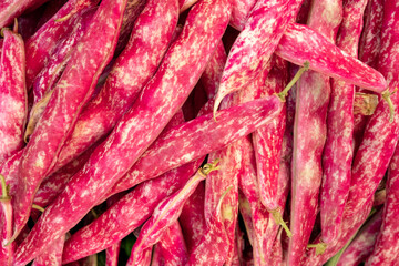 Healthy and fresh kidney beans in pods at the Farmer's market, delicious legume with high nutritional values, variety of the common bean, Phaseolus vulgaris producing the familiar kidney-shaped pulses