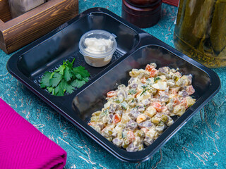Russian salad in the plastic box ready for delivery