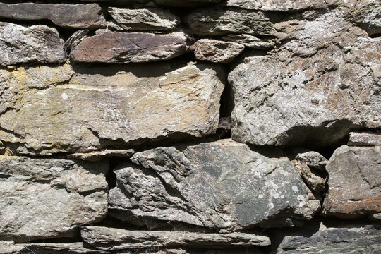 Wild stone wall in sunlight