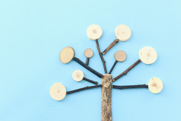 Image of wooden growing family tree on blue background

