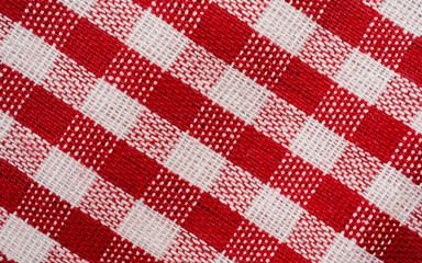 Red checkered fabric tablecloth pattern texture background diagonal view