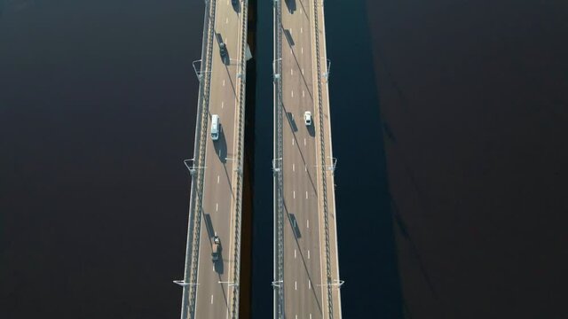 Cars traffic on bridge over the river in city, aerial view. Top view of bridge over Sozh river in Gomel, Belarus. Birds eye view cityscape
