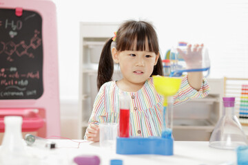 young  girl  play science experiments for homeschooling